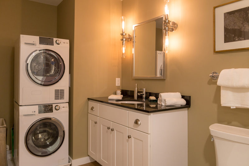 Bathroom with washer/dryer in a one bedroom apartment in Pontiac Lofts Building #1 at Pontiac Mills in Warwick, Rhode Island outside of Providence