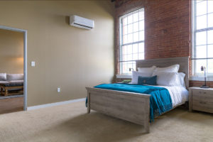 Bedroom in a one bedroom apartment in Pontiac Lofts Building #1 at Pontiac Mills in Warwick, Rhode Island outside of Providence