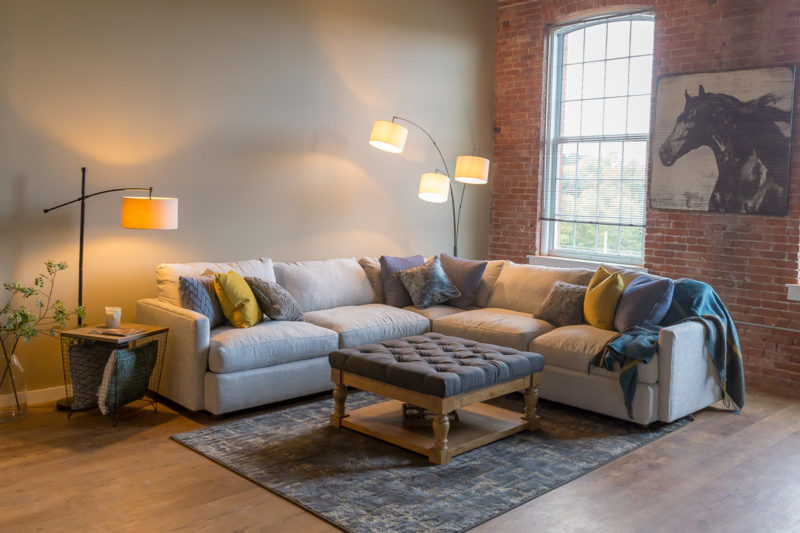 Living room in a one bedroom apartment in Pontiac Lofts Building #1 at Pontiac Mills in Warwick, Rhode Island outside of Providence